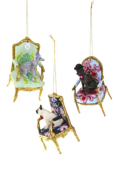 Decorative ornaments of dogs in chairs with floral patterns on a white background